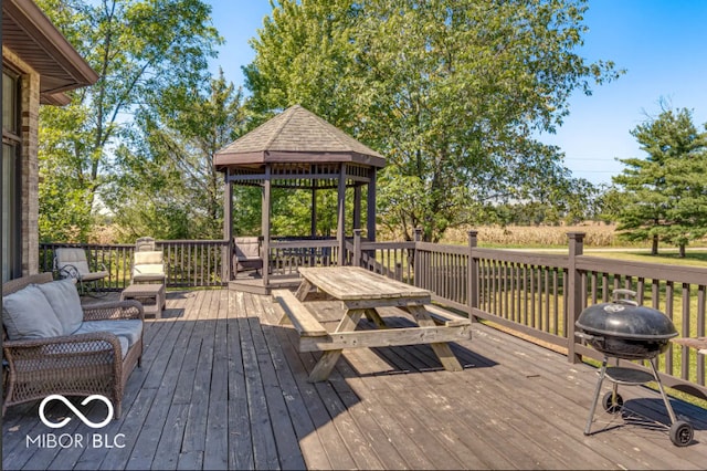 wooden terrace featuring area for grilling and a gazebo