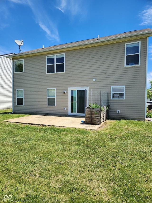 rear view of house featuring a patio and a yard