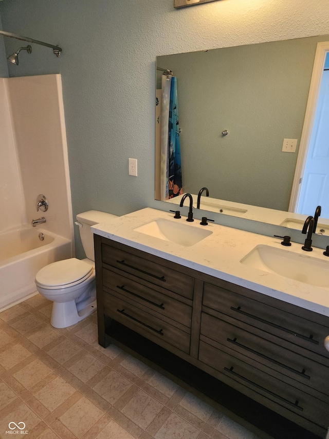 bathroom with double vanity, shower / bath combo with shower curtain, tile patterned floors, and toilet