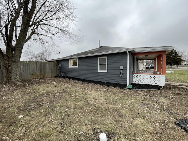 rear view of property with a lawn