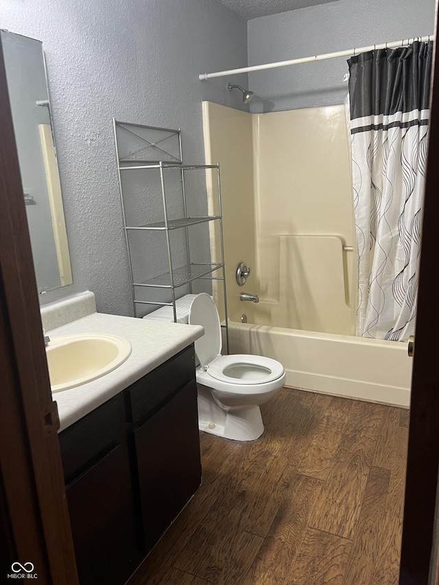 full bathroom with vanity, wood-type flooring, shower / bath combination with curtain, and toilet