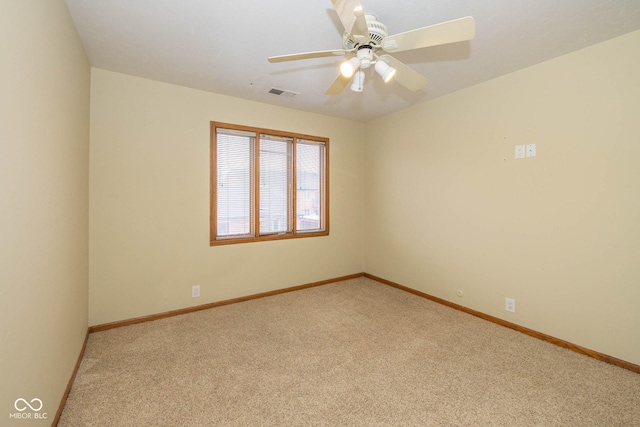 empty room featuring ceiling fan and light carpet