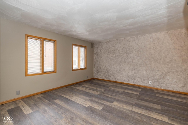 spare room with dark hardwood / wood-style floors