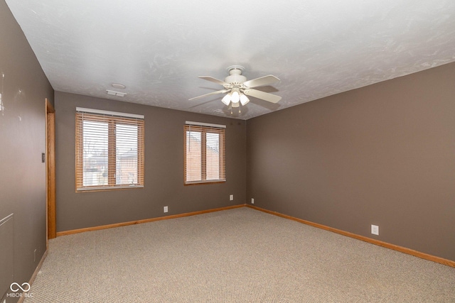 unfurnished room with carpet floors, a textured ceiling, and ceiling fan