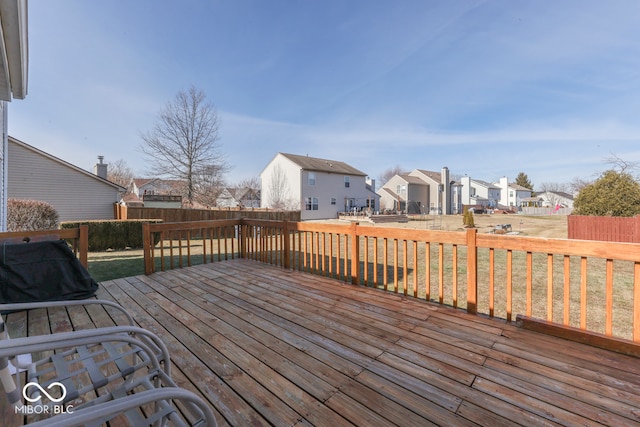 wooden deck featuring a lawn