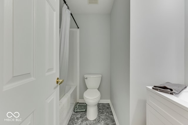 bathroom featuring shower / bath combo and toilet