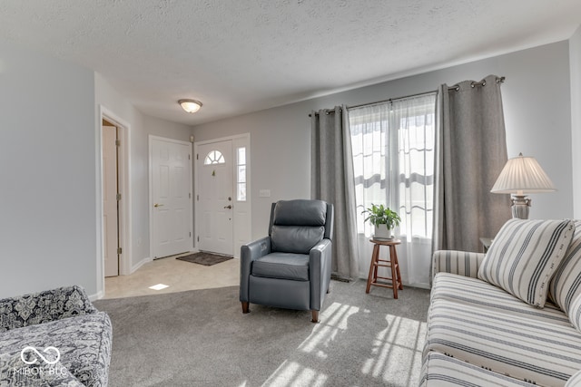 carpeted living room featuring a textured ceiling