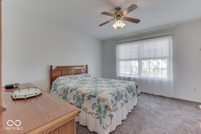 bedroom with ceiling fan and light carpet