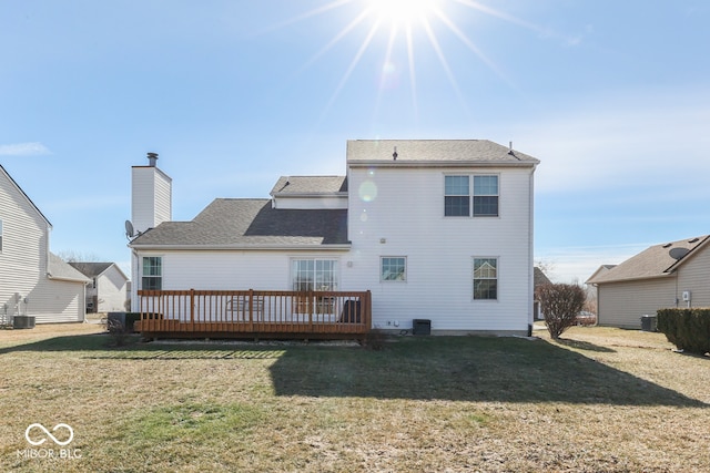 back of property featuring a yard, central air condition unit, and a deck