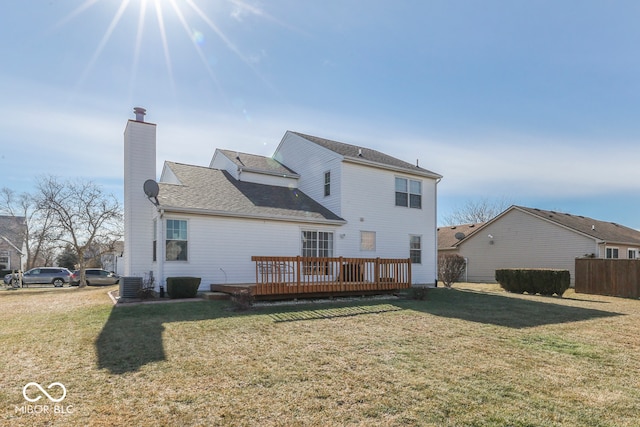 rear view of house featuring central AC unit, a lawn, and a deck