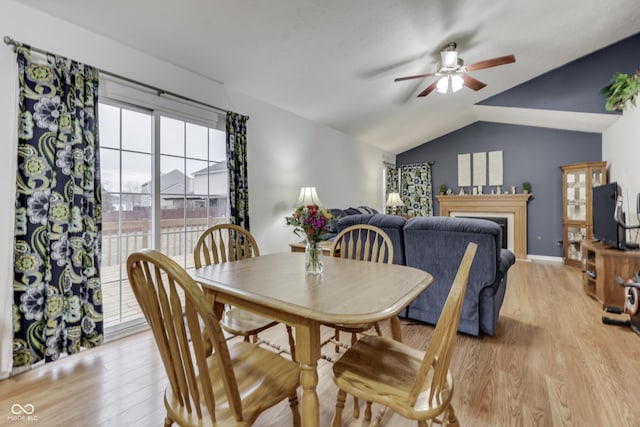 dining room featuring vaulted ceiling, ceiling fan, and light hardwood / wood-style floors