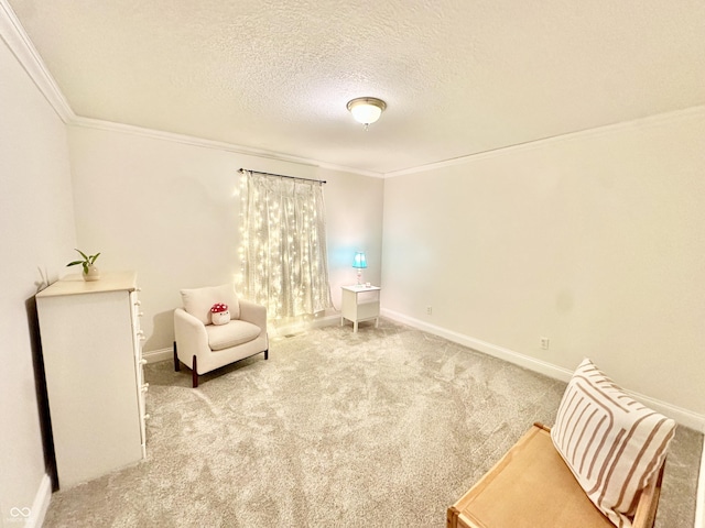 living area with ornamental molding, a textured ceiling, and carpet