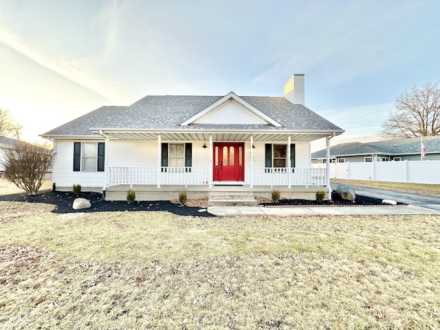 view of front of house with a porch and a front yard