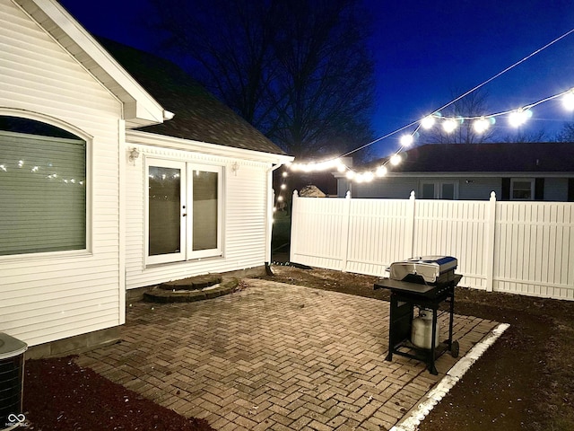 patio at twilight featuring area for grilling and french doors