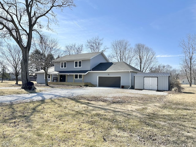 traditional-style home featuring a garage, a storage shed, dirt driveway, an outdoor structure, and a front yard