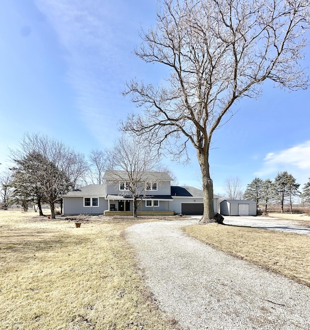 view of front of house with driveway and an outdoor structure