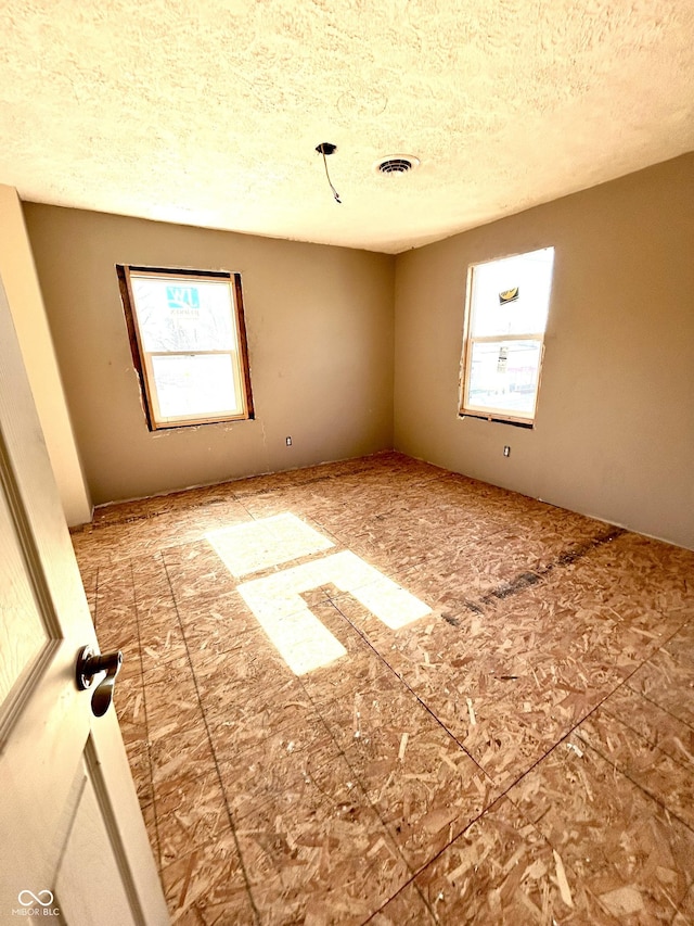 spare room featuring a textured ceiling