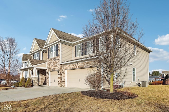 view of front of home with a garage, central AC unit, and a front lawn