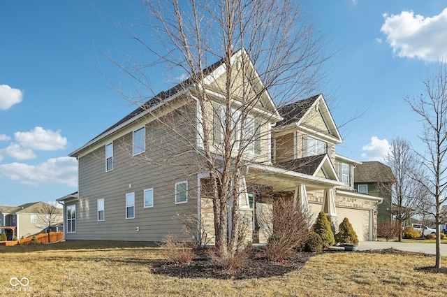 view of side of property featuring a yard and a garage