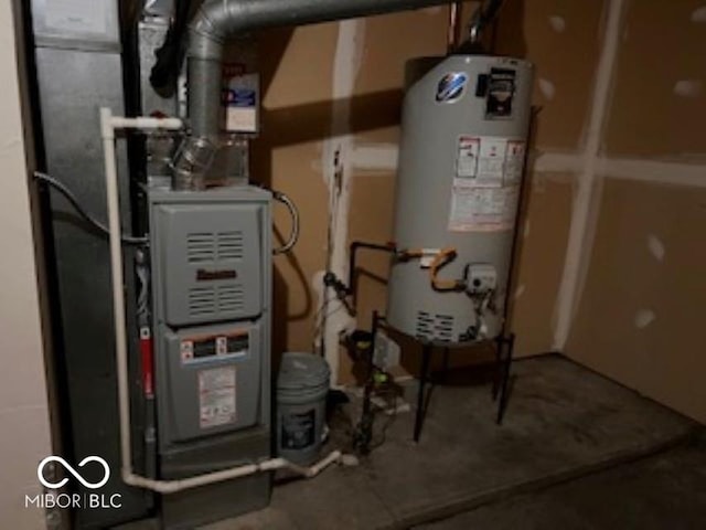 utility room with heating unit and water heater