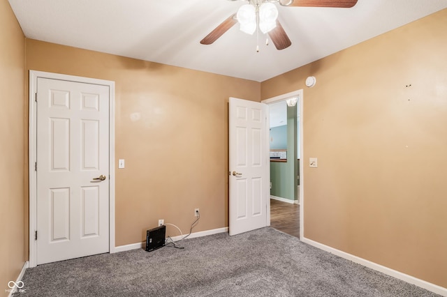 unfurnished bedroom featuring ceiling fan and carpet