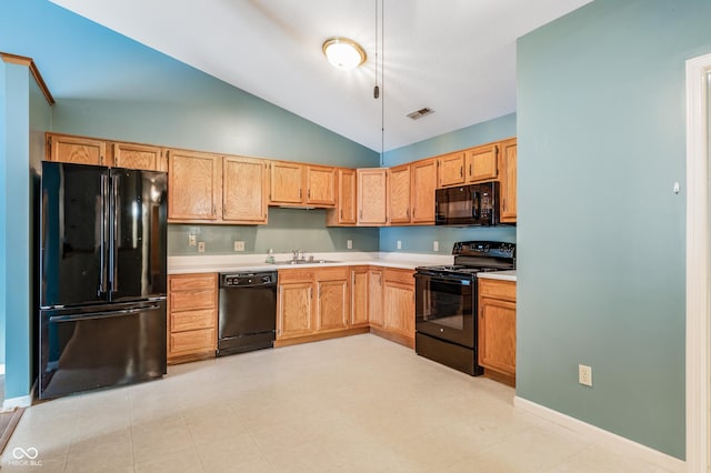 kitchen featuring lofted ceiling, sink, and black appliances