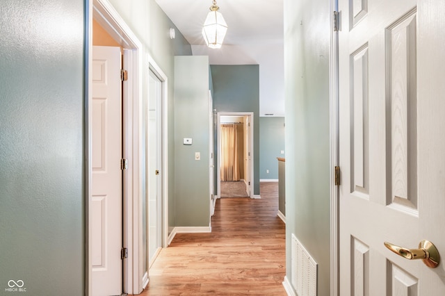 corridor with light hardwood / wood-style flooring