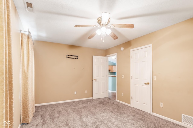 carpeted spare room with ceiling fan