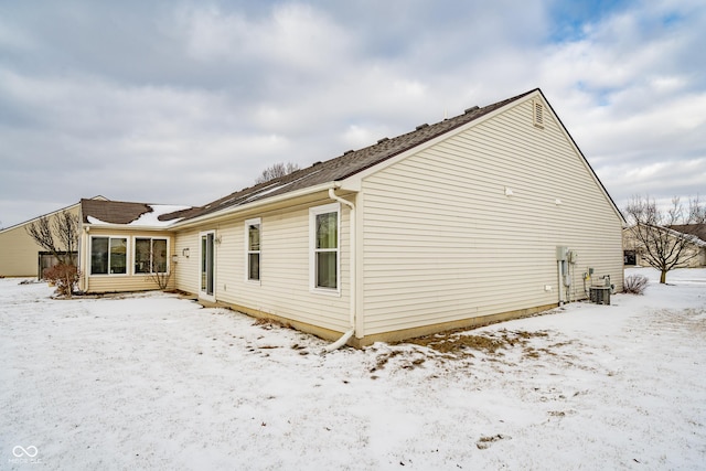 view of snowy exterior featuring central AC