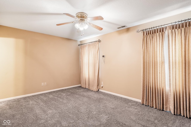 spare room featuring ceiling fan, carpet, and a textured ceiling