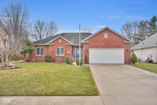 single story home with a garage and a front lawn