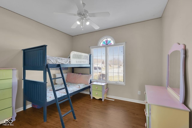 bedroom with dark hardwood / wood-style flooring, multiple windows, and ceiling fan