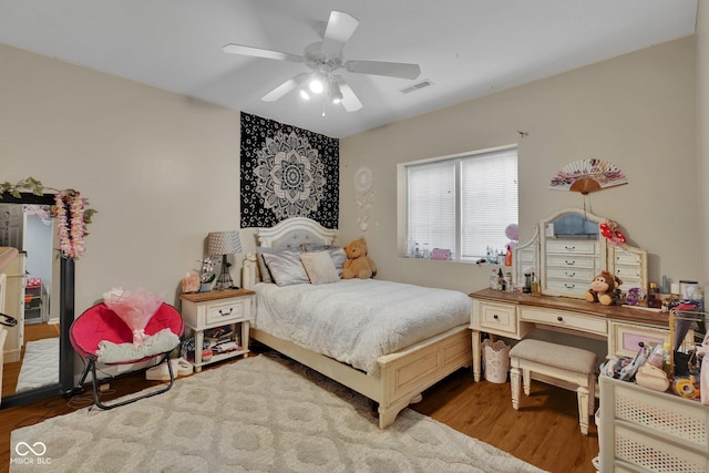 bedroom with ceiling fan and hardwood / wood-style floors