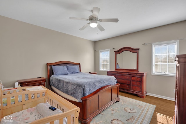 bedroom with ceiling fan and light hardwood / wood-style floors