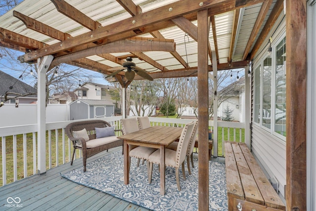 deck featuring a yard, ceiling fan, and a shed