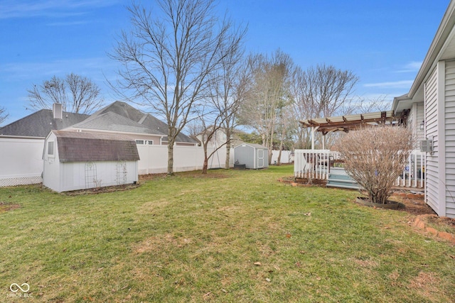 view of yard with a storage unit and a pergola