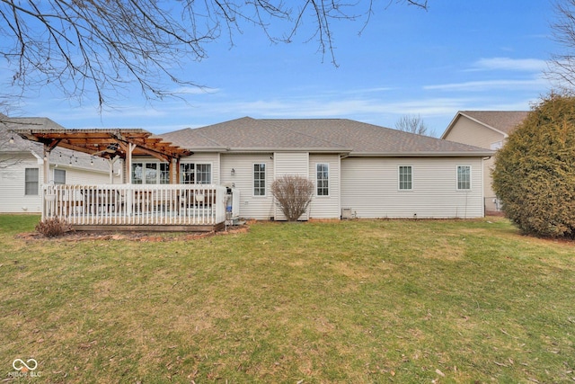 back of house featuring a yard and a pergola