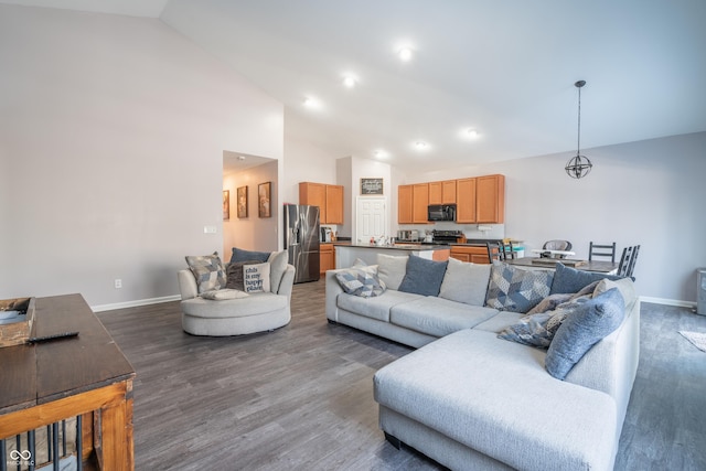 living room featuring dark wood-type flooring and high vaulted ceiling