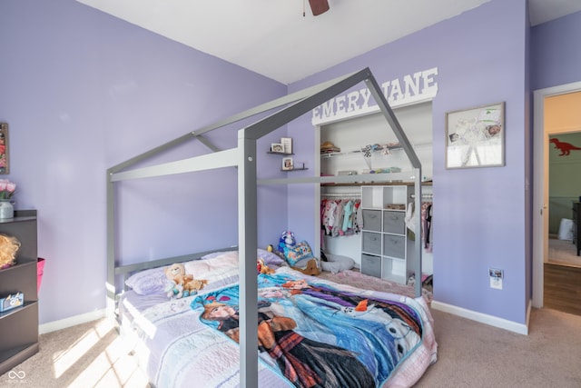 carpeted bedroom with ceiling fan and a closet