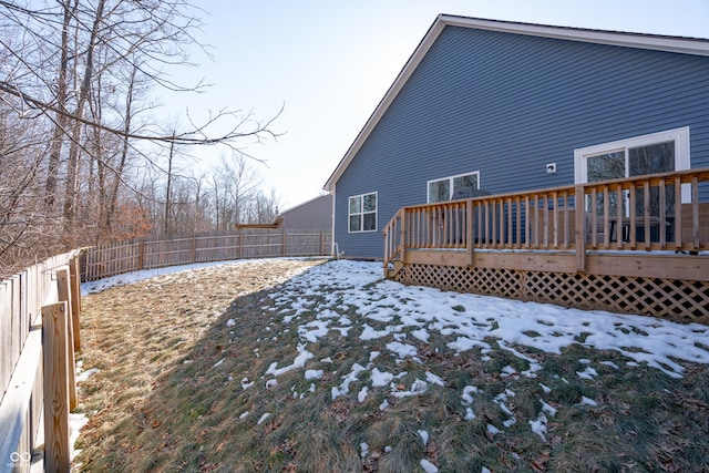 snow covered property with a deck