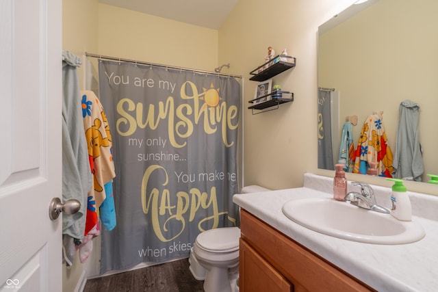 bathroom featuring walk in shower, vanity, toilet, and hardwood / wood-style floors