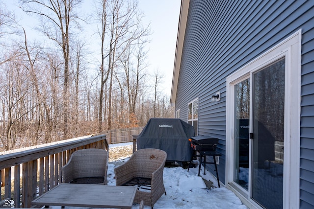 snow covered deck with grilling area