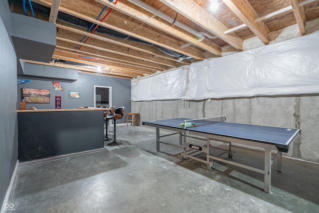 playroom featuring concrete floors and indoor bar