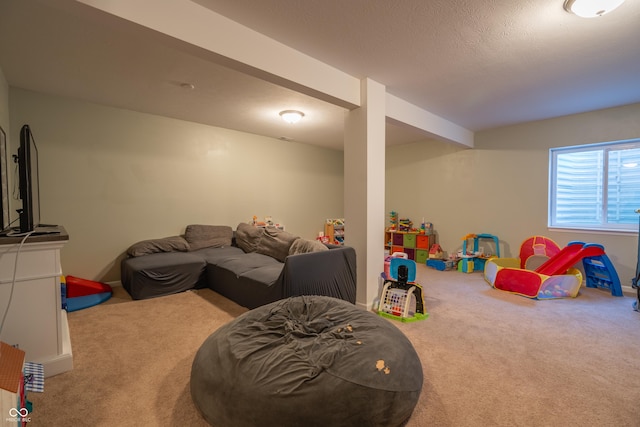 playroom featuring a textured ceiling and carpet flooring