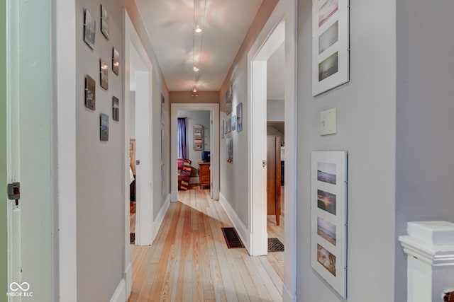 hallway with light wood-type flooring