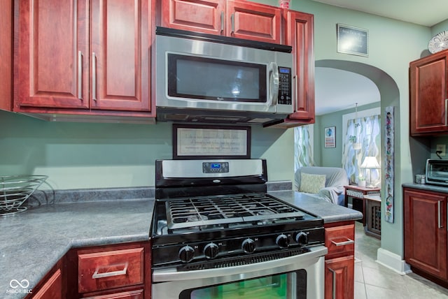 kitchen featuring light tile patterned floors and appliances with stainless steel finishes