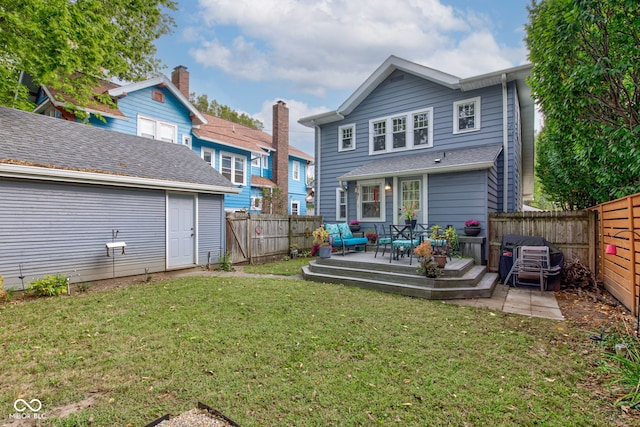 rear view of house featuring a wooden deck and a lawn