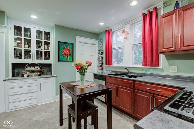 kitchen featuring dishwasher, sink, range with gas cooktop, and light tile patterned floors