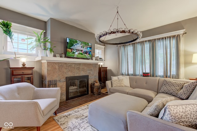 living room featuring wood-type flooring and a tile fireplace