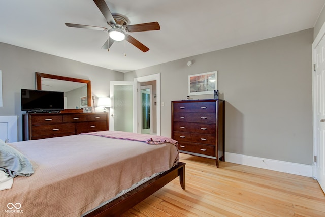 bedroom with ceiling fan and light hardwood / wood-style floors